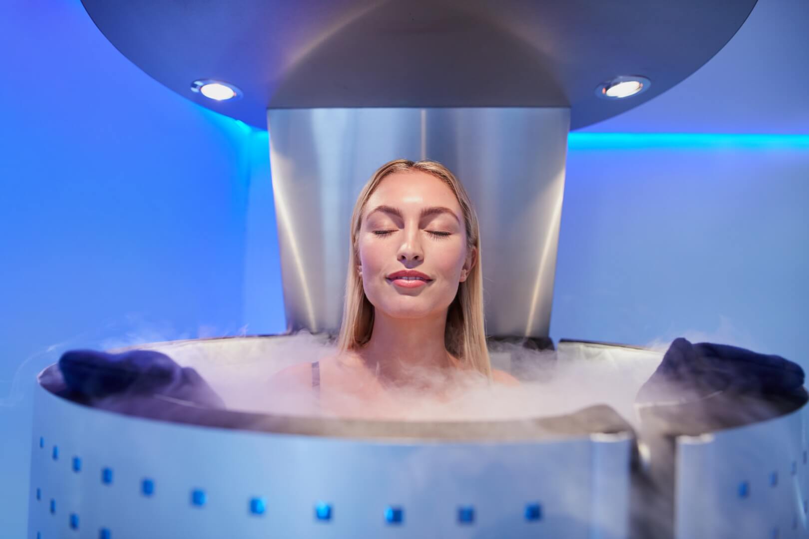 Young woman in a whole body cryotherapy cabin